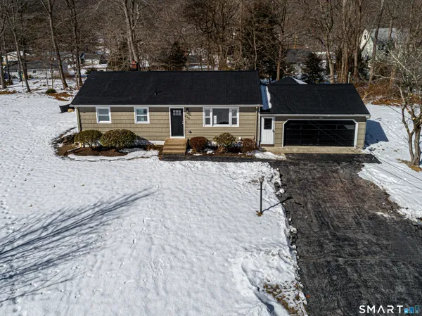 a front view of a house with yard fire pit and outdoor seating