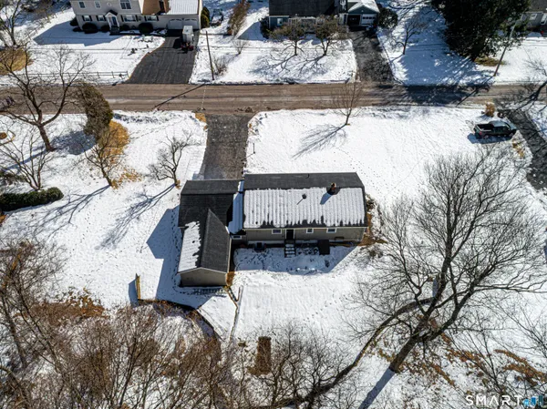 a view of a house with a snow in the yard