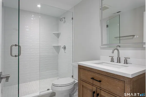 a bathroom with a sink toilet and shower