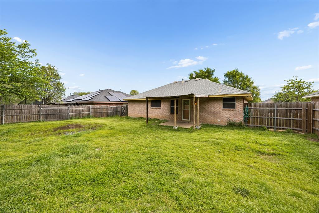 303 Vista Ridge Drive Venus, TX 76084 - Photo 22 of 25 a front view of a house with a garden