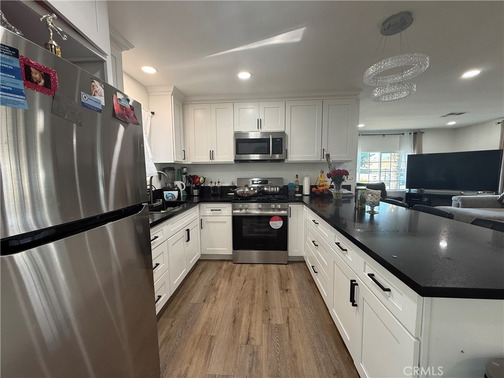 227 Palos Verdes Drive Santa Ana, CA 92704 - Photo 16 of 41 a kitchen with stainless steel appliances granite countertop a refrigerator a stove a sink and a oven