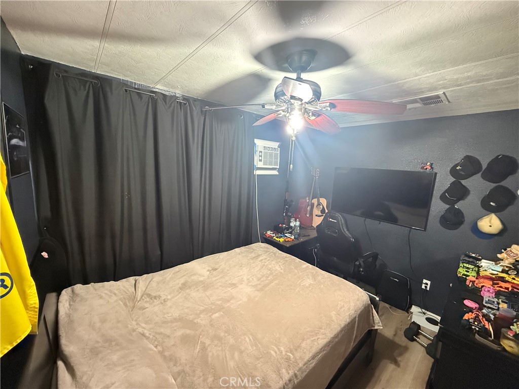 227 Palos Verdes Drive Santa Ana, CA 92704 - Photo 20 of 41 a bedroom with a bed and a chandelier