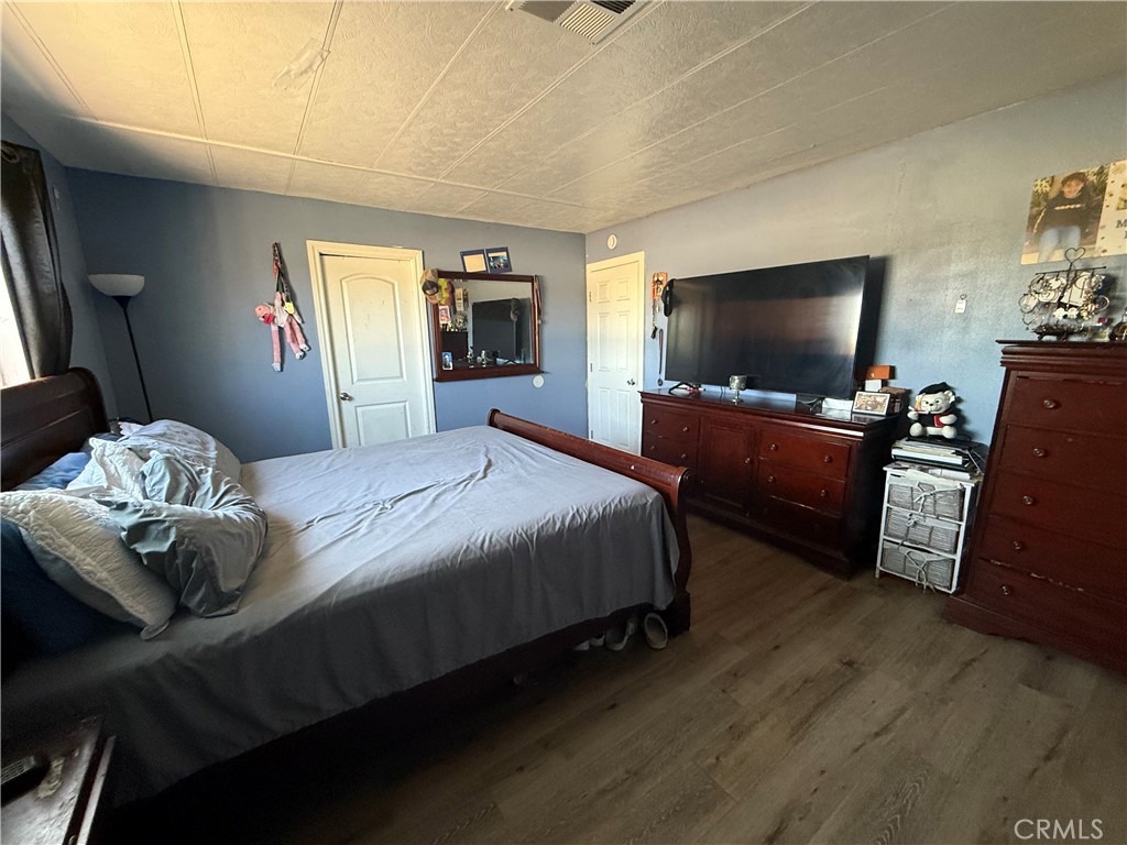 227 Palos Verdes Drive Santa Ana, CA 92704 - Photo 32 of 41 a bedroom with bed table and flat screen tv