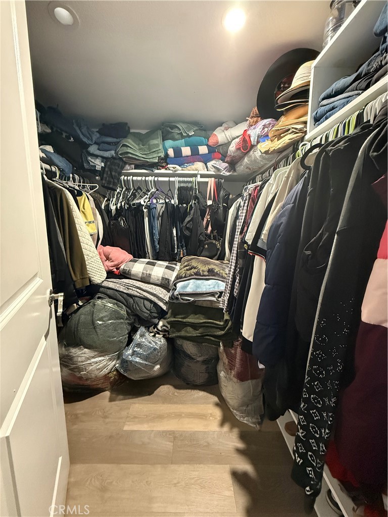 227 Palos Verdes Drive Santa Ana, CA 92704 - Photo 33 of 41 a view of walk in closet with clothes and shoes