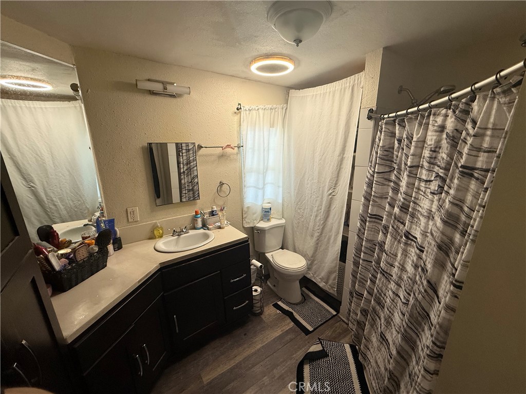 227 Palos Verdes Drive Santa Ana, CA 92704 - Photo 35 of 41 a bathroom with a sink mirror and a toilet