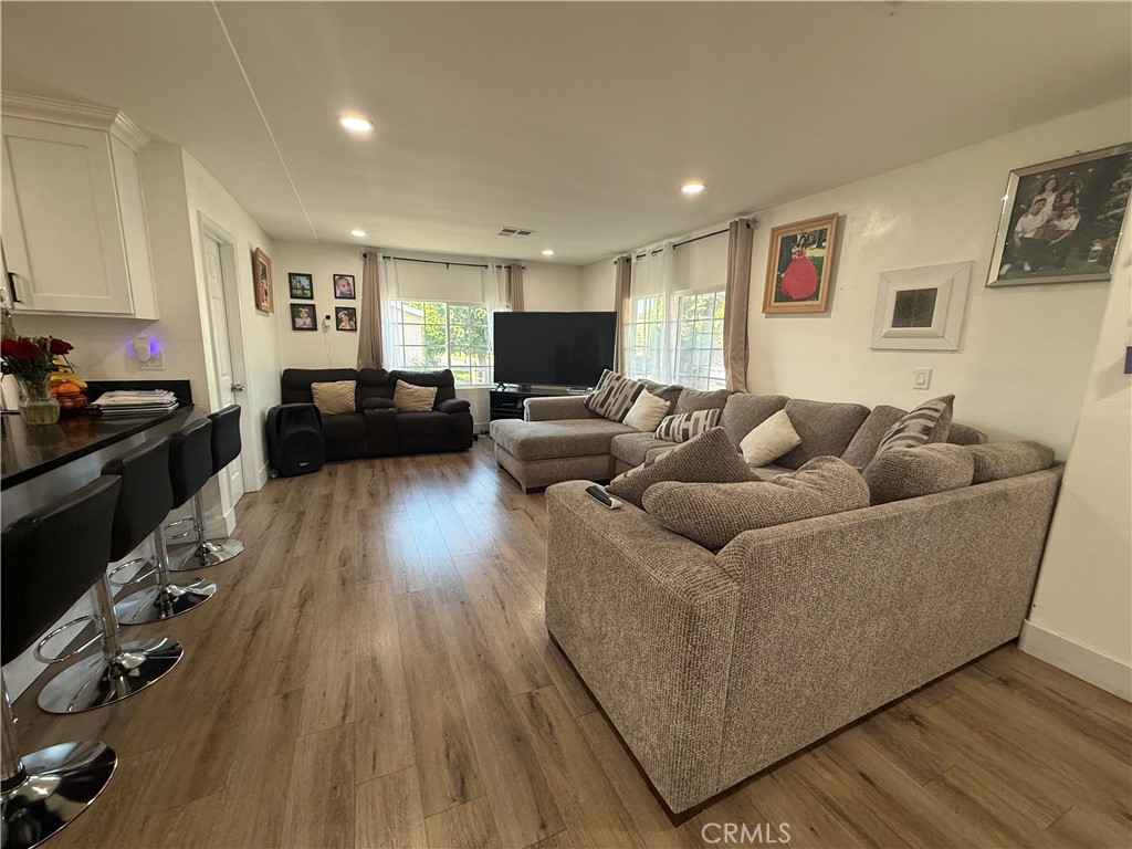 227 Palos Verdes Drive Santa Ana, CA 92704 - Photo 8 of 41 a living room with furniture and a wooden floor