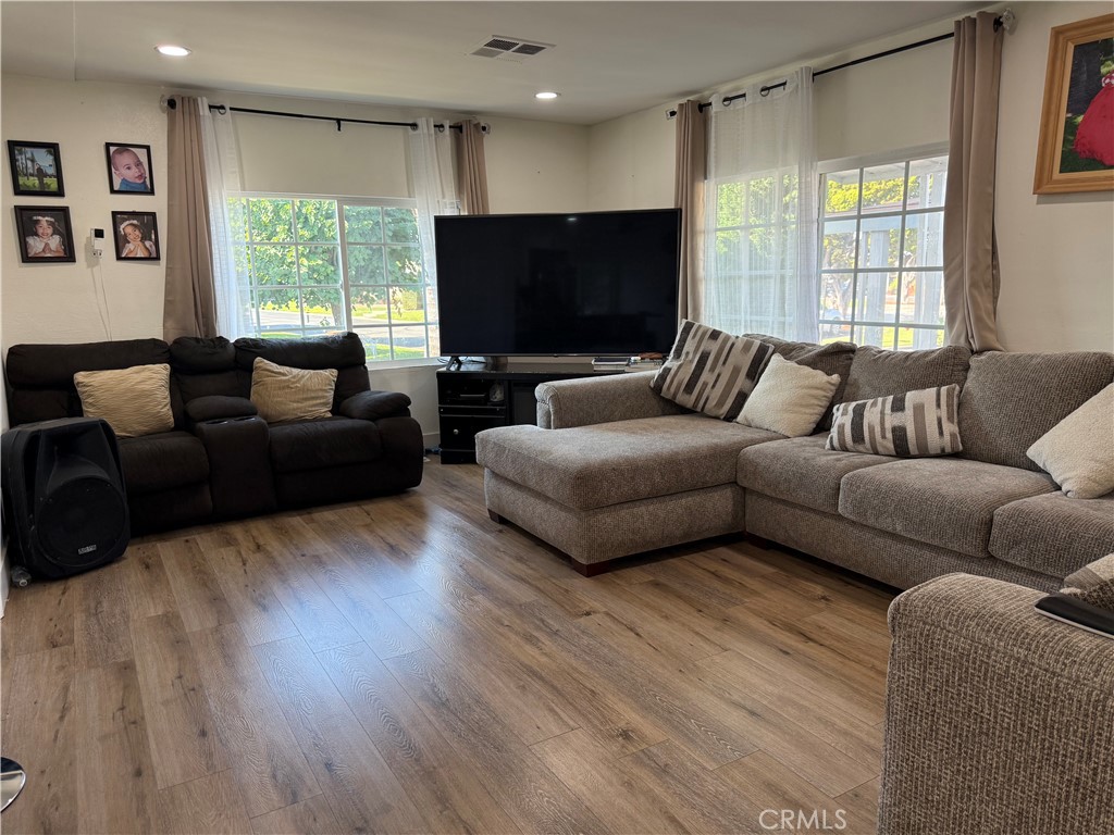 227 Palos Verdes Drive Santa Ana, CA 92704 - Photo 9 of 41 a living room with furniture a flat screen tv and a large window