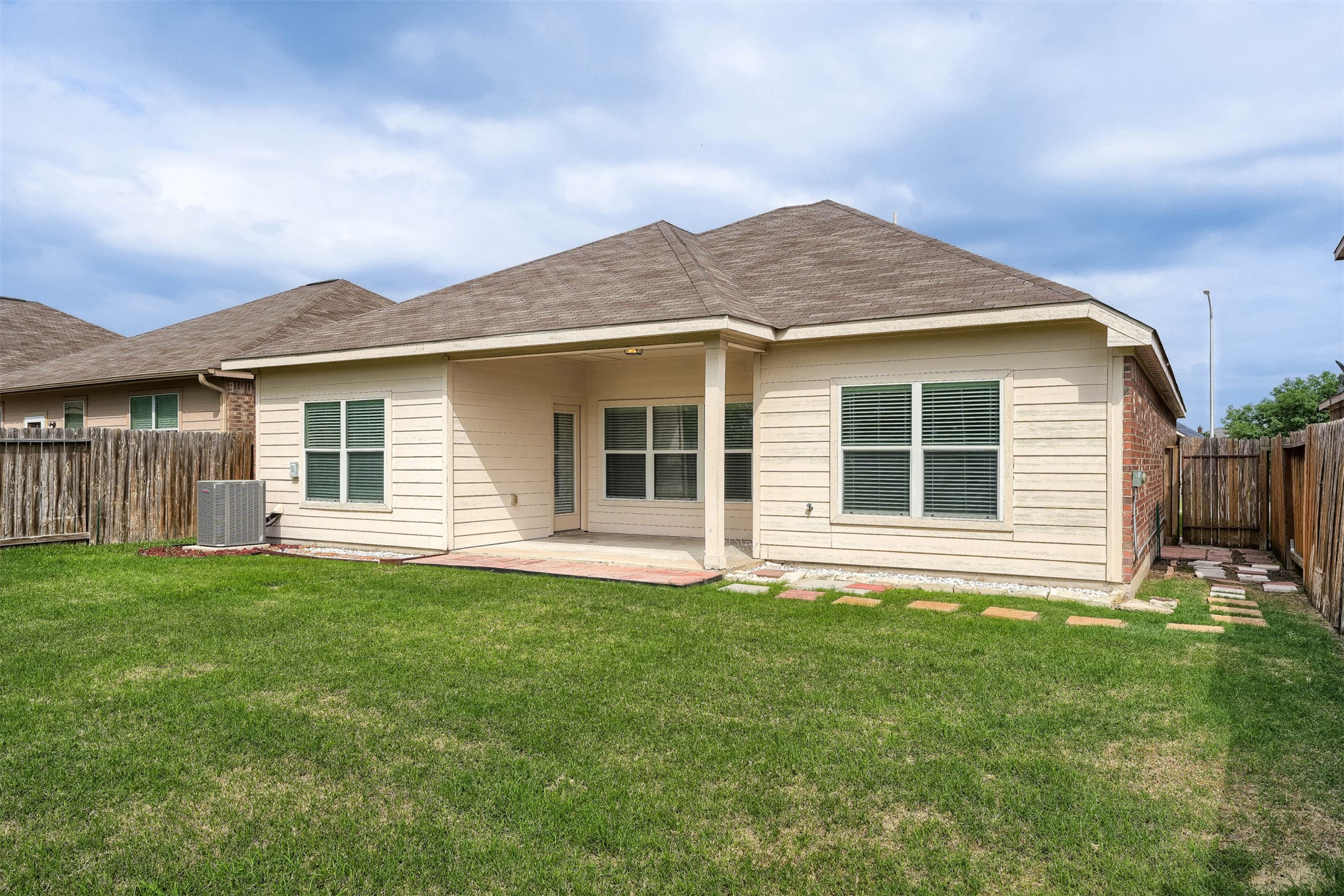 13408 Clara Martin Road Manor, TX 78653 - Photo 27 of 27 a house that has a big yard in front of it