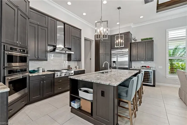 a kitchen with stainless steel appliances granite countertop a stove top oven a sink dishwasher a dining table and chairs