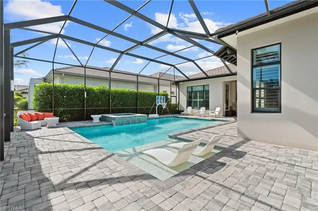 a view of a patio with a table and chairs under an umbrella