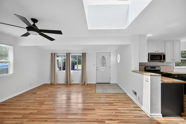 a view of a kitchen with wooden floor and a sink