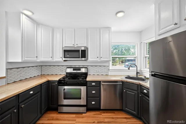 a kitchen with a sink stove and microwave