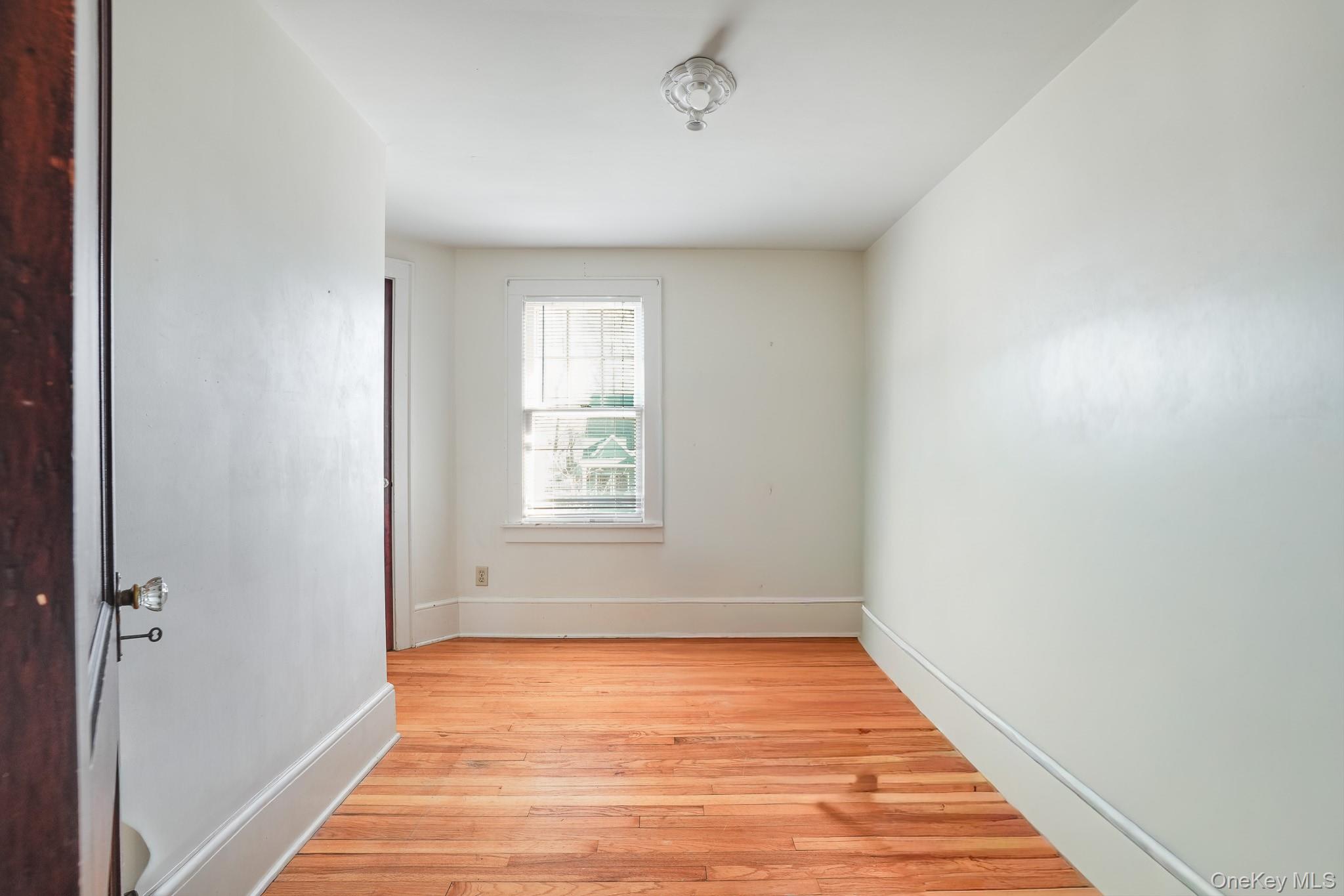 31 Wilson Boulevard Poughkeepsie, NY 12603 - Photo 16 of 36 a view of an empty room with wooden floor and a window