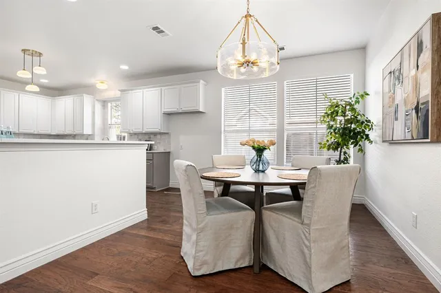 a view of kitchen with dining table and chairs