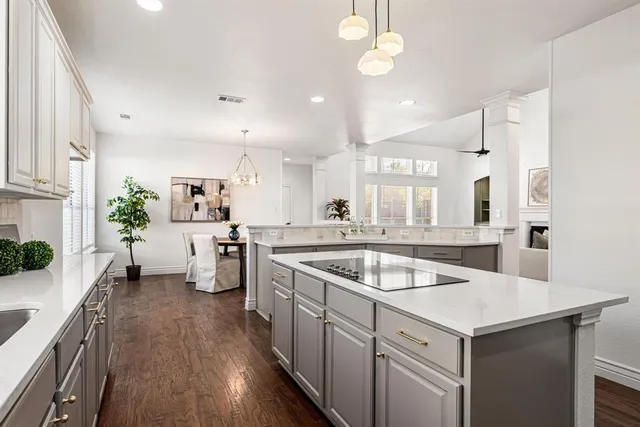 a kitchen with granite countertop a sink a counter top space stainless steel appliances and cabinets