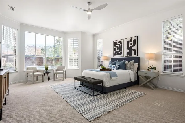 a bedroom with a bed and a large window