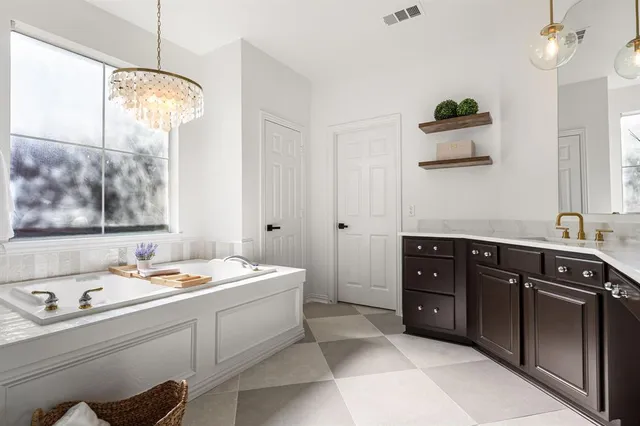 a room with a sink and a bed