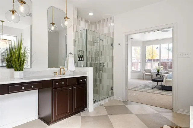 a spacious bathroom with a shower sink and mirror