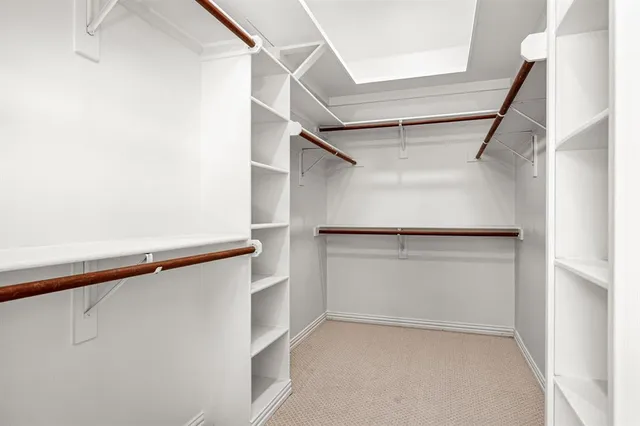 a view of walk in closet with empty racks