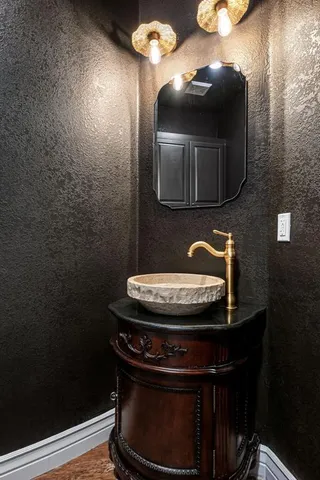 a bathroom with a toilet and a mirror