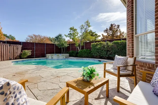 a view of a backyard with wooden fence