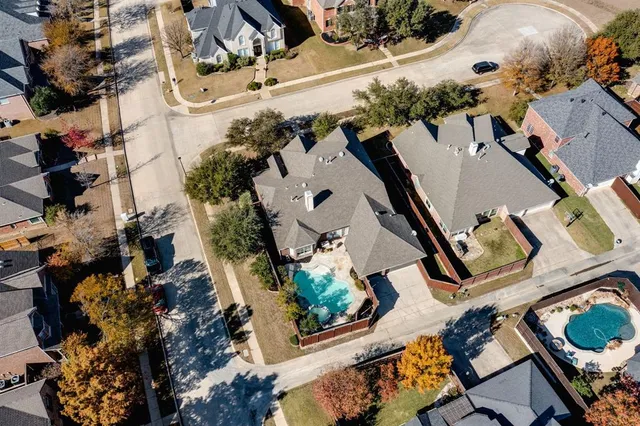 an aerial view of a house with a yard and lake view