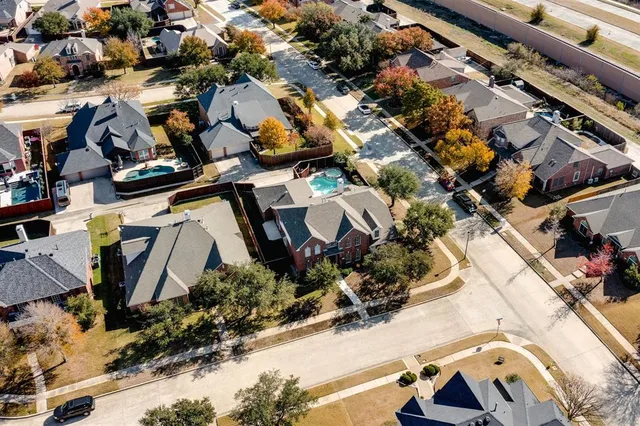 an aerial view of multiple houses with yard