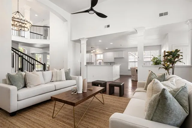 a living room with furniture kitchen view and a table