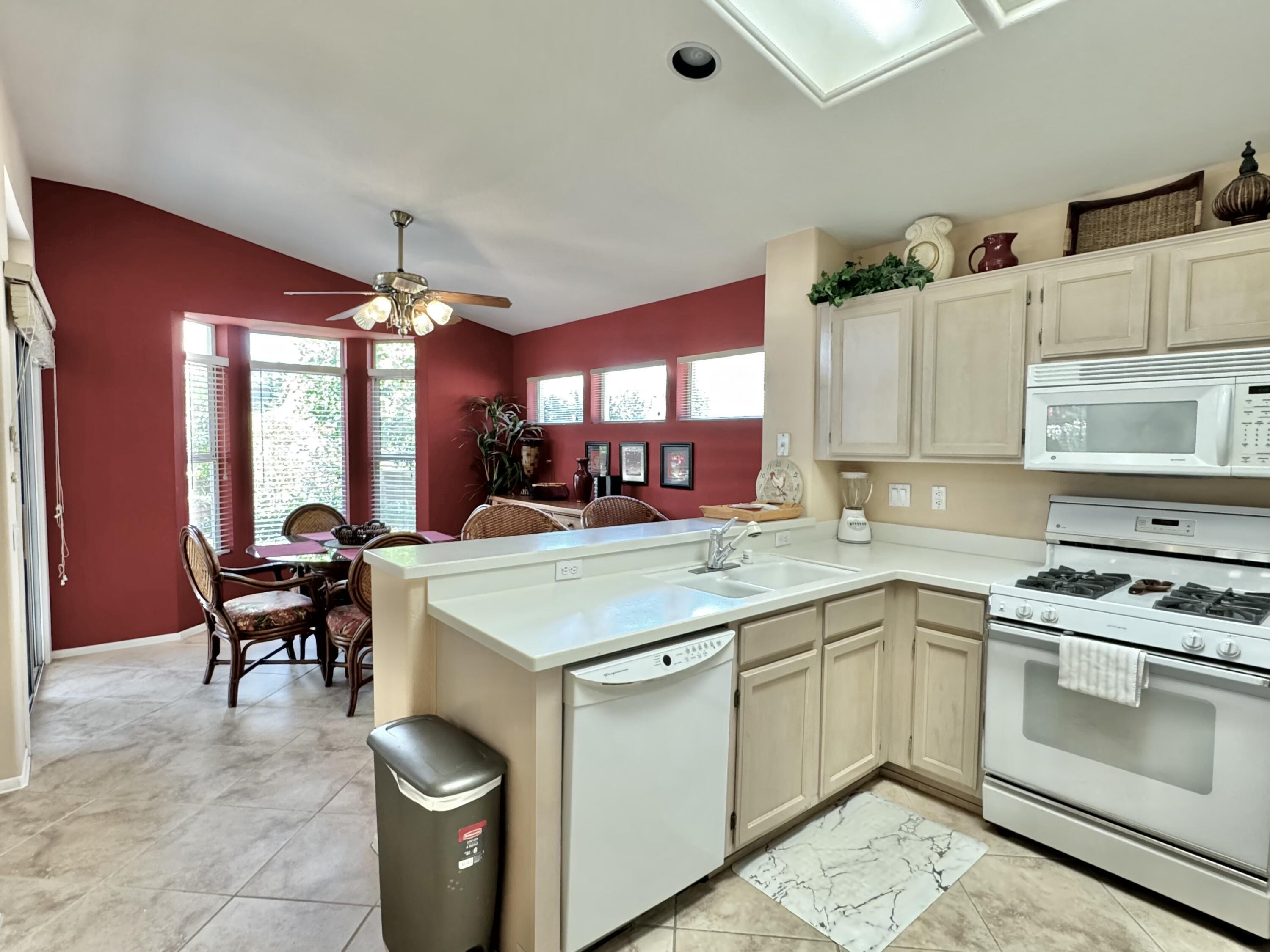 78376 Moongold Road Palm Desert, CA 92211 - Photo 4 of 36 a kitchen with a sink and a stove top oven