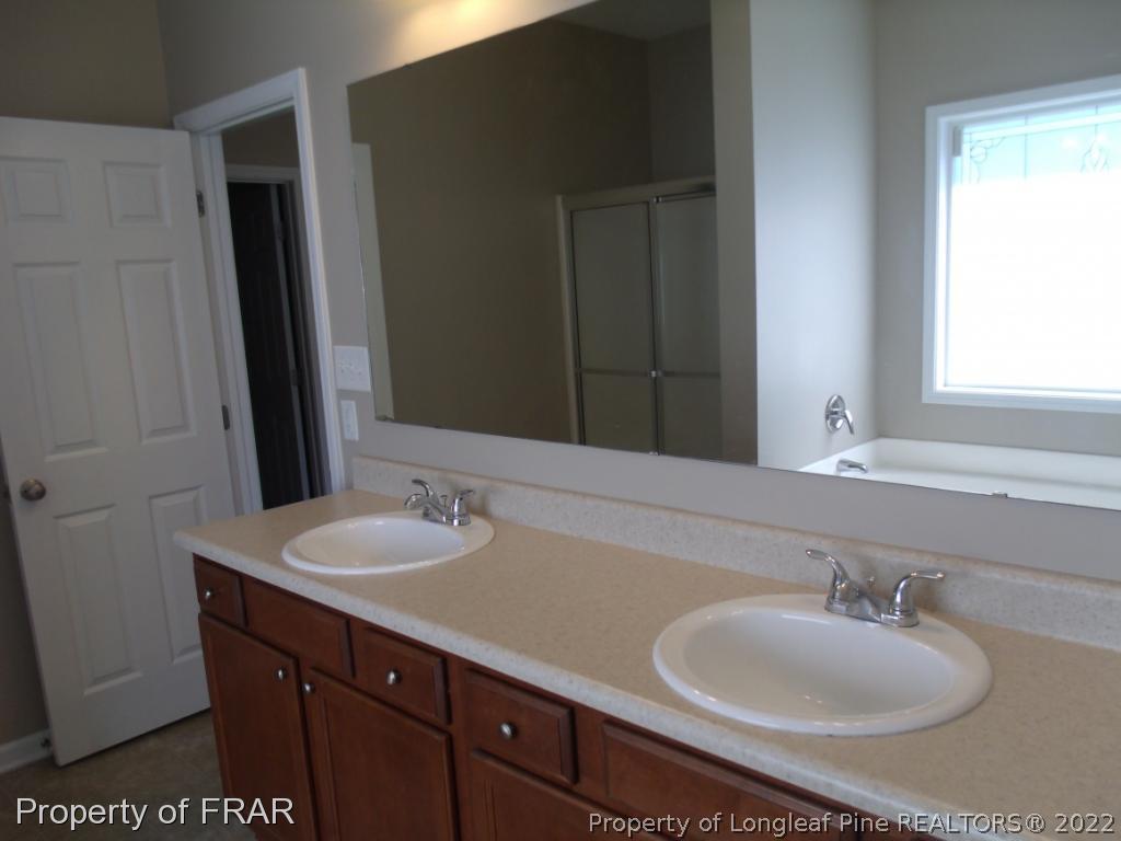 1448 Rough Rider Lane Parkton, NC 28371 - Photo 20 of 36 a bathroom with a sink and a mirror