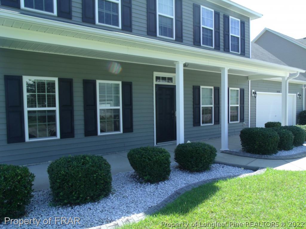 1448 Rough Rider Lane Parkton, NC 28371 - Photo 2 of 36 a view of a house with potted plants and a yard