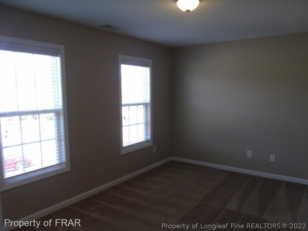 1448 Rough Rider Lane Parkton, NC 28371 - Photo 21 of 36 an empty room with wooden floor and windows