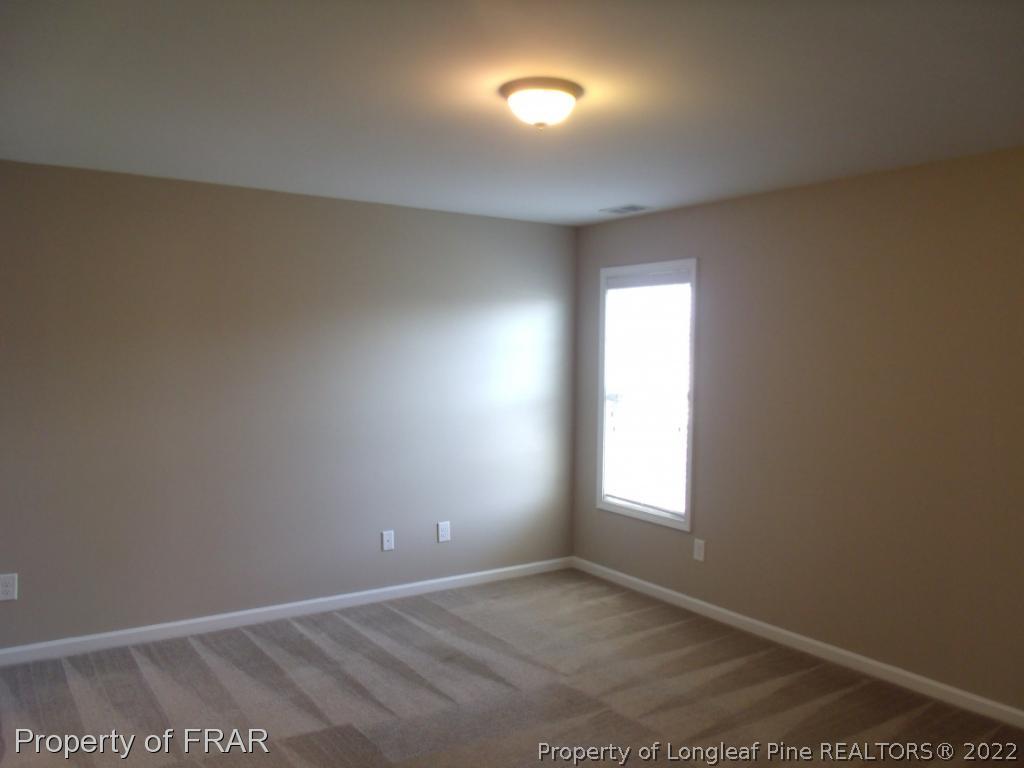 1448 Rough Rider Lane Parkton, NC 28371 - Photo 24 of 36 an empty room with windows and closet