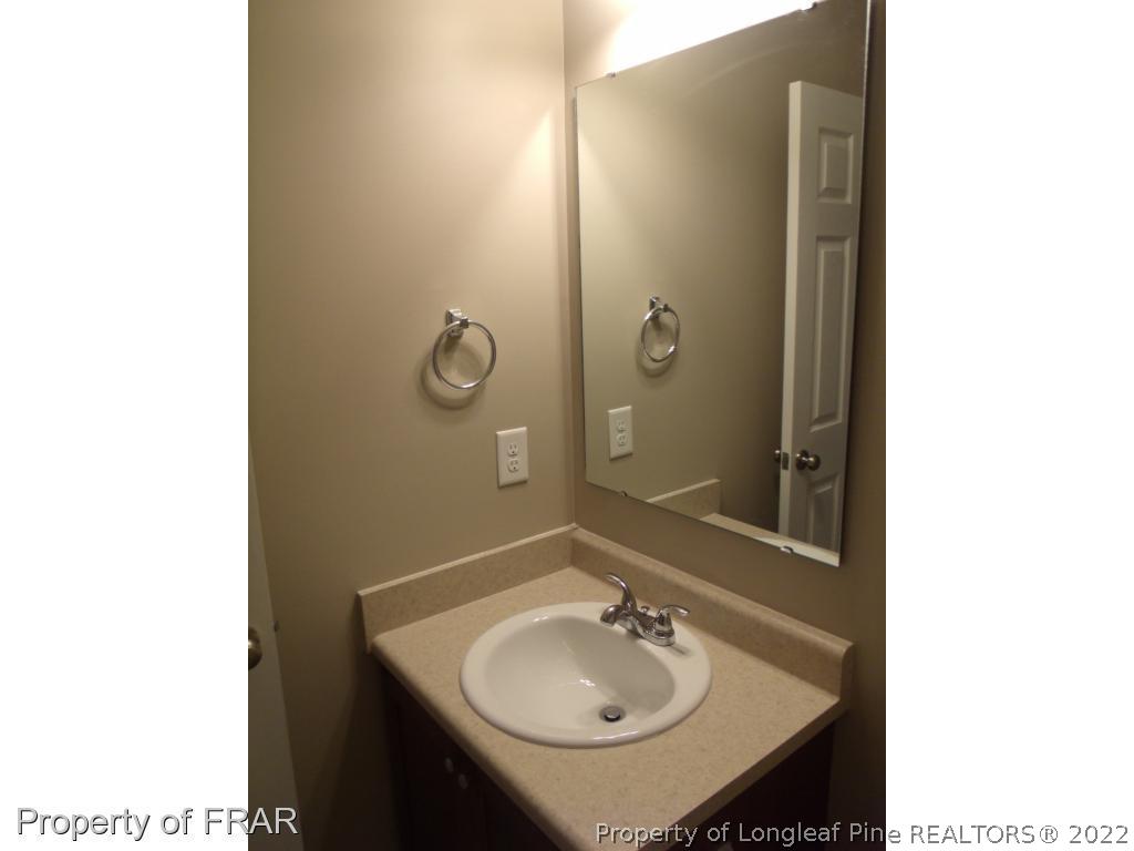 1448 Rough Rider Lane Parkton, NC 28371 - Photo 28 of 36 a bathroom with a sink and a mirror