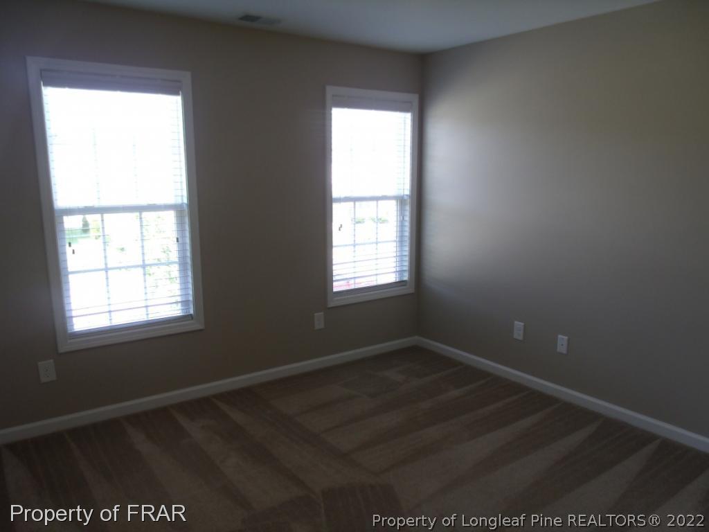 1448 Rough Rider Lane Parkton, NC 28371 - Photo 29 of 36 an empty room with wooden floor and windows