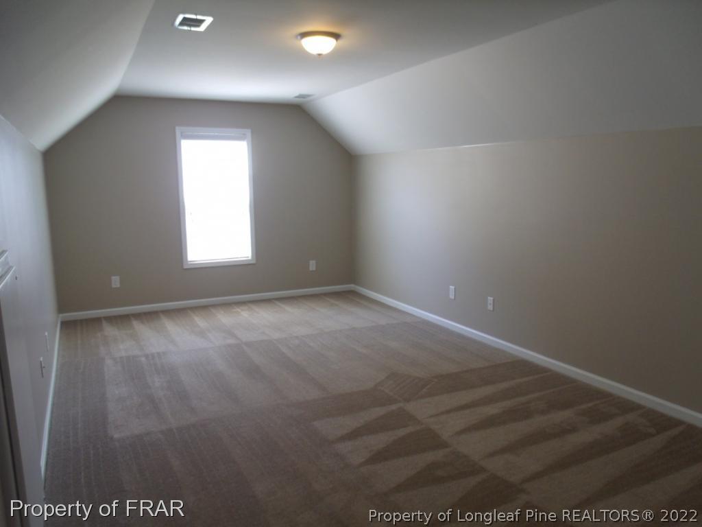 1448 Rough Rider Lane Parkton, NC 28371 - Photo 30 of 36 an empty room with wooden floor and windows
