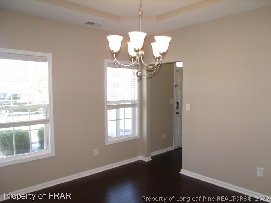 1448 Rough Rider Lane Parkton, NC 28371 - Photo 6 of 36 a view of empty room with wooden floor and fan