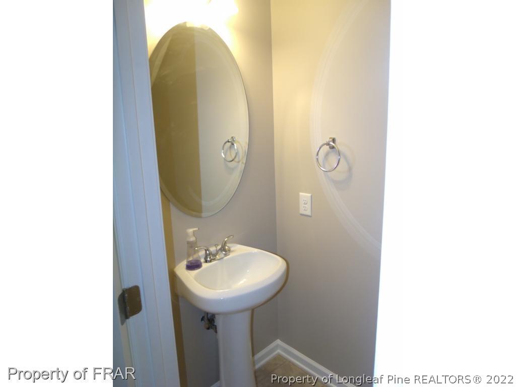 1448 Rough Rider Lane Parkton, NC 28371 - Photo 7 of 36 a bathroom with a sink and mirror