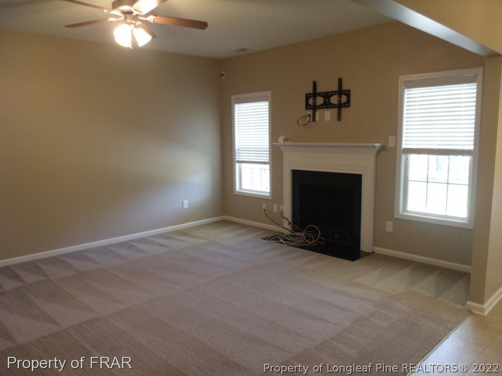 1448 Rough Rider Lane Parkton, NC 28371 - Photo 8 of 36 a view of an empty room with window and fireplace