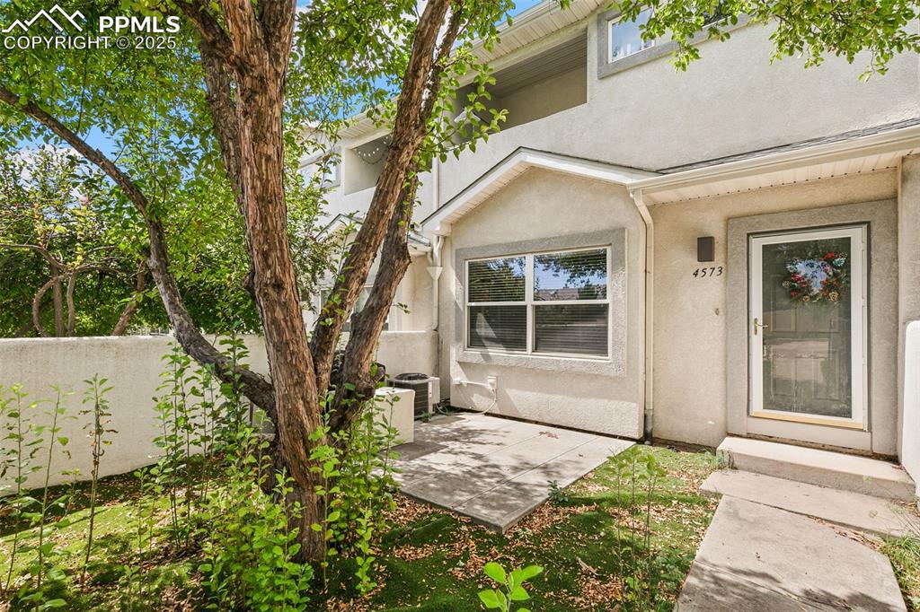 4573 Prestige Point Colorado Springs, CO 80906 - Photo 1 of 31 Entrance to property featuring stucco siding and a patio area