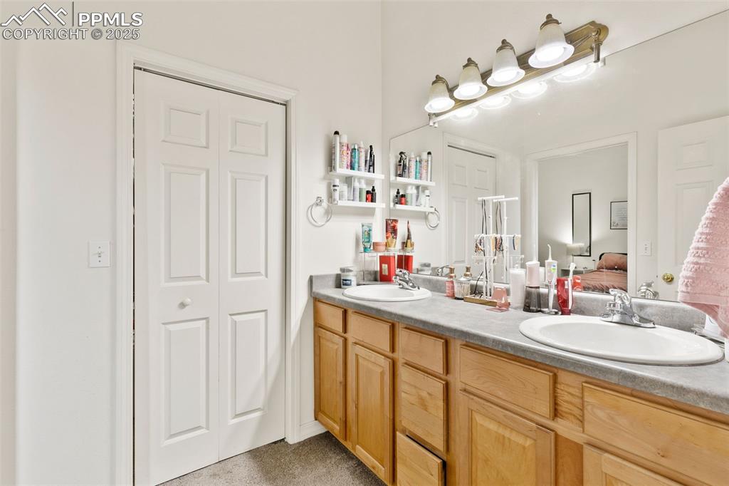 4573 Prestige Point Colorado Springs, CO 80906 - Photo 21 of 31 Full bathroom featuring a closet, ensuite bathroom, and double vanity