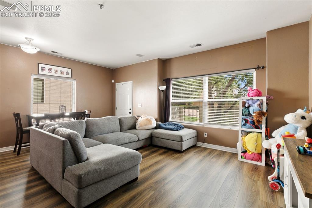 4573 Prestige Point Colorado Springs, CO 80906 - Photo 6 of 31 Living area featuring baseboards and wood finished floors