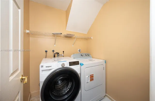 a view of storage and utility room with washer and dryer