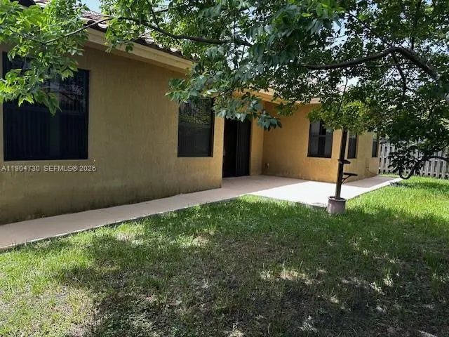 a view of a backyard with a tree