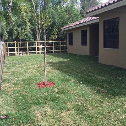 a view of a tree in front of a house