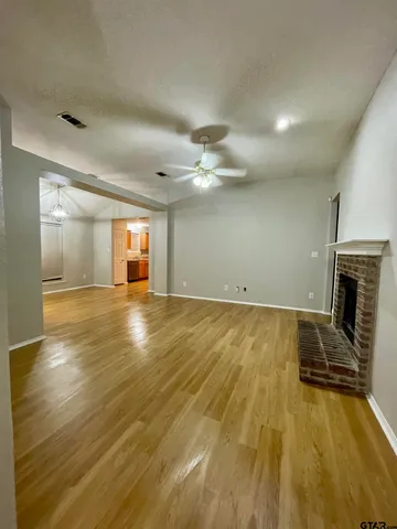 wooden floor in an empty room with a fireplace