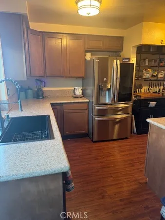 a kitchen with stainless steel appliances granite countertop a sink and a stove