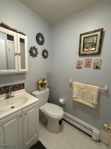 a bathroom with a sink mirror vanity and toilet