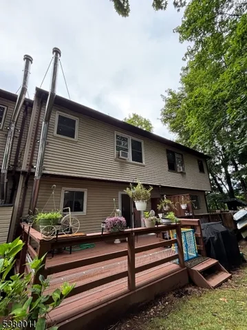 a front view of a house with lots of trees