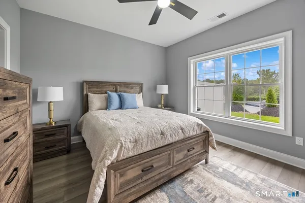 a spacious bedroom with a bed and a large window